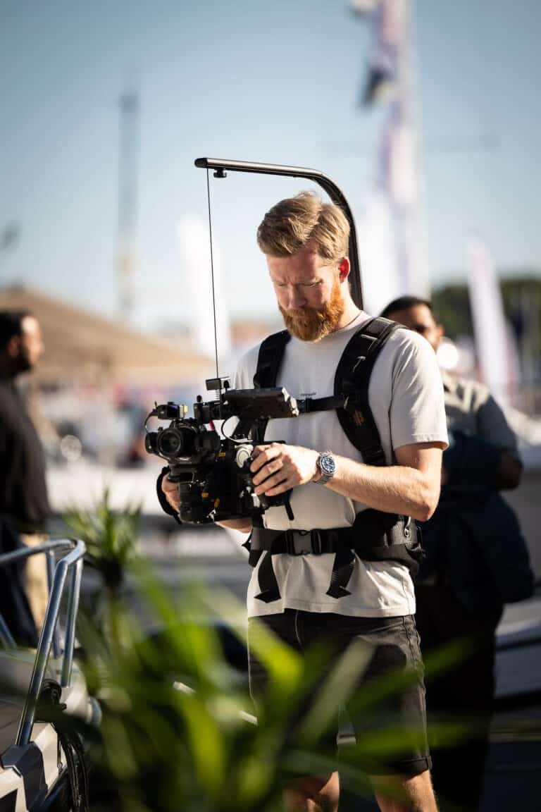 close up av marius som filmer fra båter i sjøen på aker brygge under båtmessen